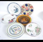 A large collection of Bristol pottery plates to include character series ware, blue and white,
