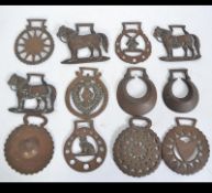 A collection of horse brasses to include shire horses, Queen Victoria, crescent moon, cat,