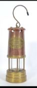 An Insurance Institute of Newcastle Upon Tyne brass and copper tilley miners lamp with handle atop
