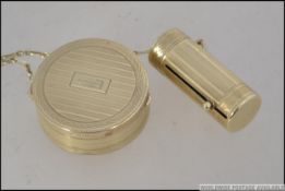A vintage Houbigant of France Art Deco gilt metal Powder Compact and telescopic lipstick holder