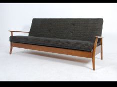 A 1960's Danish inspired sofa day bed with the original upholstered seat/ bed being raised on