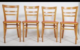 A set of 4 mid century Ben Chairs dining chairs having orange pad seats being raised on angular