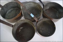 A set of five late 19th / early 20th century graduating copper saucepans.