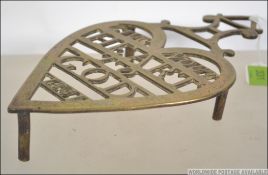 A good 19th century brass heart shaped trivet with the ' Give Your Heaart To God 1841 ' Measures: