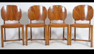 A set of 4 early 20th century Art Deco 1930's walnut scalloped shaped panel back dining chairs