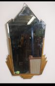 A 1930's Art Deco mirror with of olympic flame geometric form of metallic trim construction.