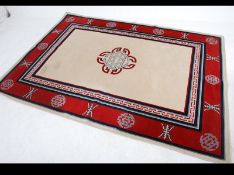 A contemporary 20th century Chinese wool rug with central medallion on beige ground having red
