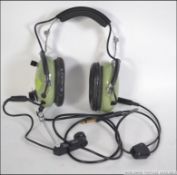 A retro pair of 1970's pilot's aviation headphones and speaker being marked for David Clark
