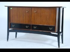 A 1970's G-Plan Librenza pattern sideboard raised on an ebonised base with suspension effect having