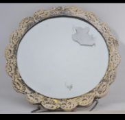 A Continental silver ( stamped 900 ) ladies mirror decorated in repose with daisies and roses.
