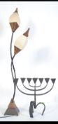 A cast iron Jewish Menorah - candelabra together with an unusual metal twin head lamp.