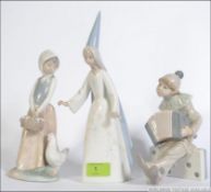 A collection of Lladro ceramic figurines to include Boy Clown with Concertina on Dominoes,
