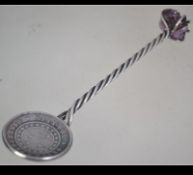 Spoon set with Brazilian coin marked ' orderprogresso 500 reis ' to front and ' Republica Dos