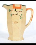 A 1930's Art Deco Clarice Cliff Bizarre 5499 Jug with orange handle and banded green rim.