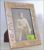 A rococo silver 925 photograph frame having easel back,