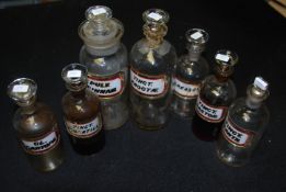 A good group of 7 antique W N Walton Chemist / Apothecary bottles with glass labels.