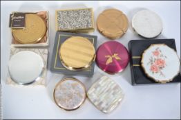 A collection of vintage ladies compacts to include boxed Stratton examples, musical etc.