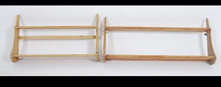 A near pair of early 20th century pine bookcase - shelves racks with shaped ends and fixed