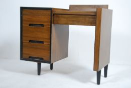 A mid century retro John and Slyvia Reid for Stag C-Range walnut dressing table with an arrangement