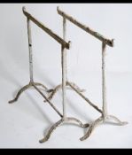 A pair of early 20th century workmens cast metal trestle ends - coffine stands ideal for conversion