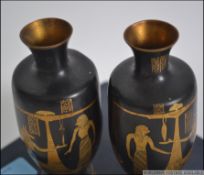A pair of early 19th century boxed Egyptian brass amphora vases with a black ground and gilt