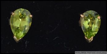 A pair of 9ct gold and marquise cut Peridot stone ladies earrings studs with posts in the