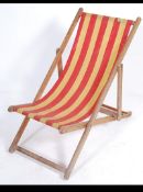 A vintage mid century folding deck chair - beech chair having striped canvas.