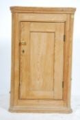 A Victorian country pine corner cabinet having a full length single door with shelved interior.
