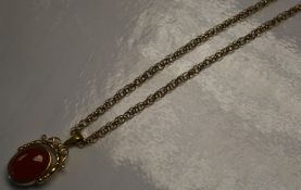 A 9ct gold swivel fob pendant on chain the fob being set with carnelian and onyx.