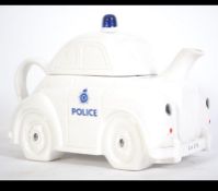 An unusual large 20th century teapot police car stamped to the underside for Carlton Ware.