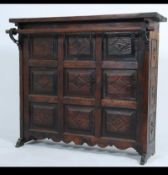 A 20th century black forest style oak bar having stud work panels to the front with scroll work