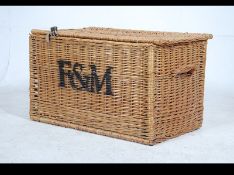 A stunning 20th century large whicker basket come laundry basket with lid attached by leather