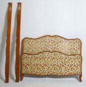 An early 20th century French corbeille bed with chenille upholstered head and footboard united by