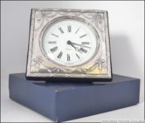 A silver hallmarked Adams revival easel backed mantel clock, hallmarked for Douglas Pell Silverware,
