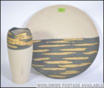 A large 20th century Italian made studio pottery wall charger along with a matching studio pottery