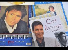A collection of Cliff Richards calendars from the late 20th century together with records - 45's