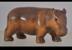 A well carved wooden Japanese netsuke in the form of a hippo,
