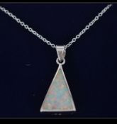 A silver triangular opal pendant set to a silver necklace chain. Complete in the presentation box.