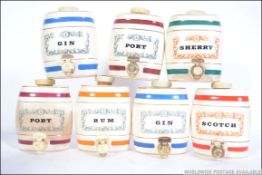 A collection of vintage breweriana items to include Wade Scotch, Gin x 2, Brandy, Rum, Port x 2,