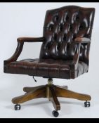 Antique Chesterfield Style mahogany and leather button back captains office swivel chair.