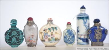 A collection of Chinese snuff - perfume bottles to include glass, blue and white ceramic,