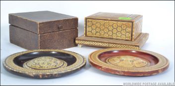 A 20th century metamorphic cigarette case along with a pair of similarly decorated plates.