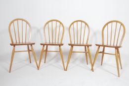 A set of 4 1970's retro hoop back beech and elm wood Ercol light dining chairs.
