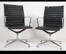 A pair of 20th century Charles Eames style office swivel chairs.