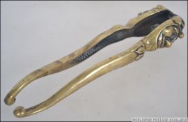 A vintage 20th century brass pair of nutcrackers in the form of Punch. Measures: 18cms long.