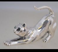 A silver ( tested ) miniature cat with emerald stone eyes. Total weight 23.