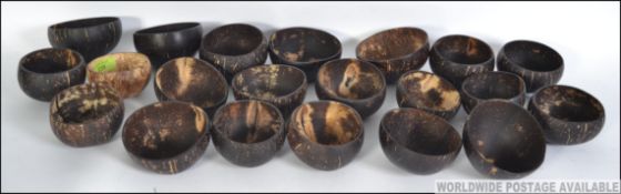 A collection of retro Bacardi style coconut drinking cups, each cup free of any husk.