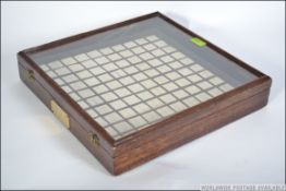 An early 20th century Jewellers wooden mahogany display cabinet of square form having a glazed and