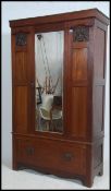 An Edwardian mahogany inlaid single wardrobe - armoire having an out swept cornice above a hanging