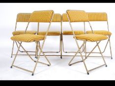 A set of retro 1970's 20th century folding conference / hall chairs by Lafuma with gilt tubular